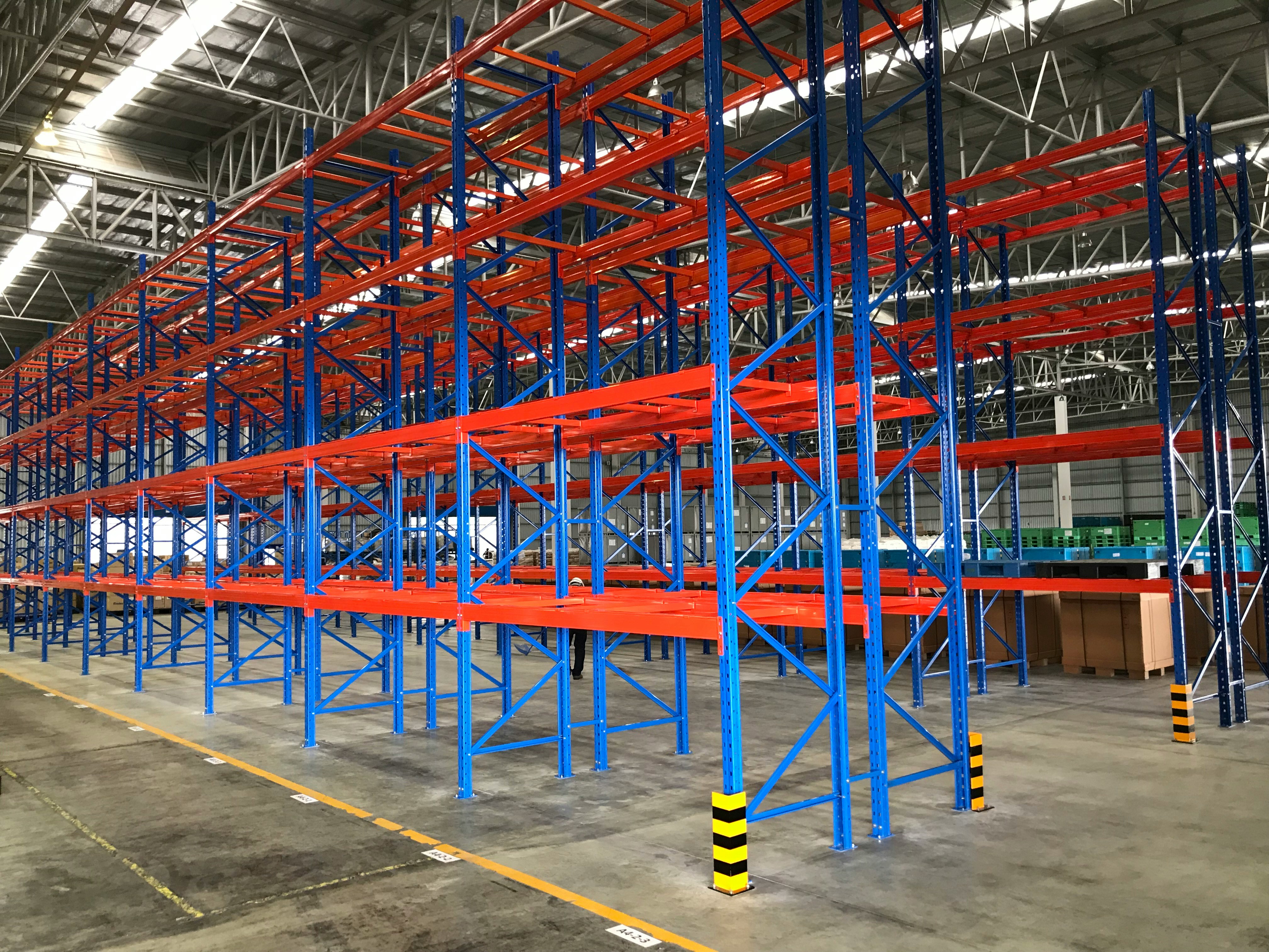 Professional pallet racking installation crew working in a DC metro area warehouse